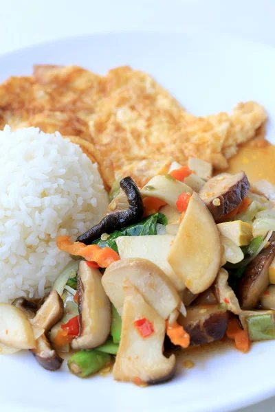 Stir Fried Tofu in Chinese Style,Stir fried tofu with mixed vegetables and fried egg in white plate with rice on white background for celebrate Chinese new year festival,Vegetarian Food, healthy food.