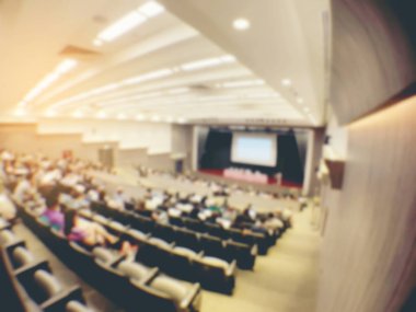 blurred image of Business Conference and Presentation. People Meeting Conference Seminar, Audience at the conference hall. - interior of a conference hall, warm & vintage tone photo. clipart