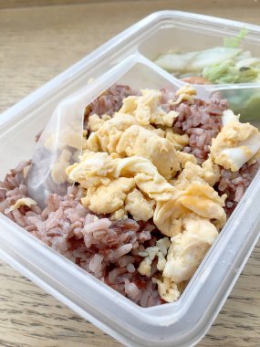 pirinç berry, domuz rostosu, omlet, ahşap arka plan üzerinde kızarmış sebze ile öğle yemeği kutusundaki temiz gıda.