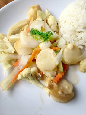 Kızarmış tofu sebze ile Tayland Yasemin pirinç ahşap arka plan üzerinde beyaz tabak ile. Gıda Tay tarzında. Vejetaryen yiyecekler.