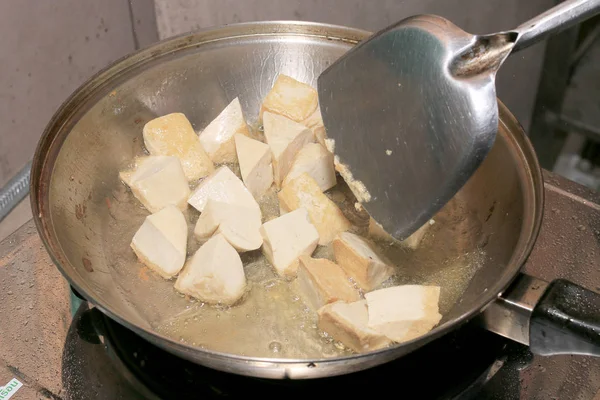 Cooking tofu fries in oil, The process of cooking frying pieces of Tofu on a special grill pan in the kitchen. Vegetarian dishes. Soy Tofu Grilled. Fried Tofu Recipe, Soft focus.