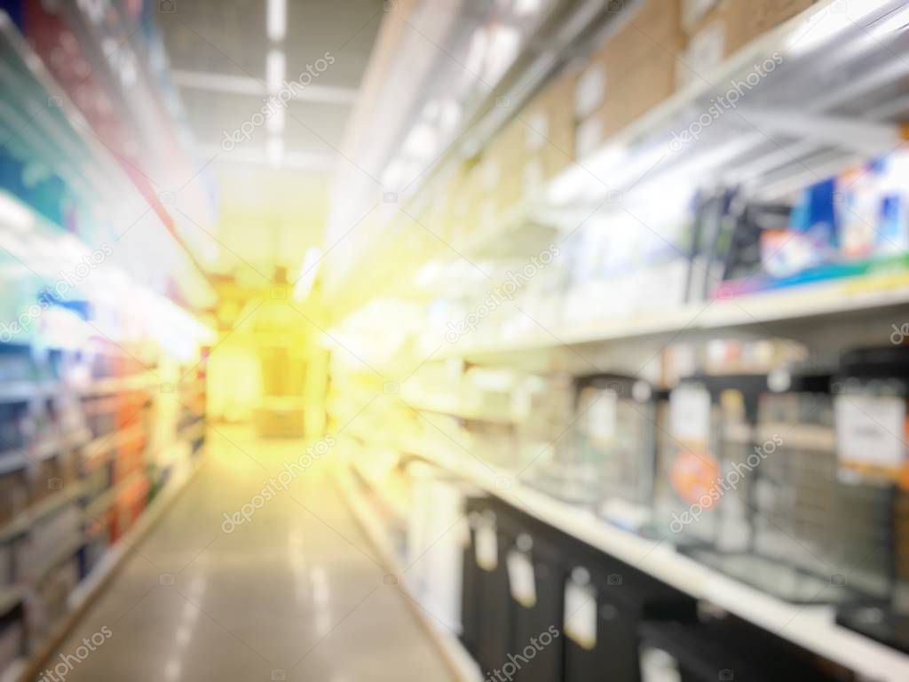 blurred image of people shopping in at hardware store or storehouse with variety of indoor & outdoor ceiling fans, flushmount,recessed,track lights, led. vintage tone with light effect.