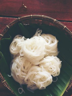 Tayland pirinç unu makarna veya pilav şehriye ahşap ilaç masada muz yaprak üzerinde beyaz. Tay tarzı yiyecek. Vintage rengi.