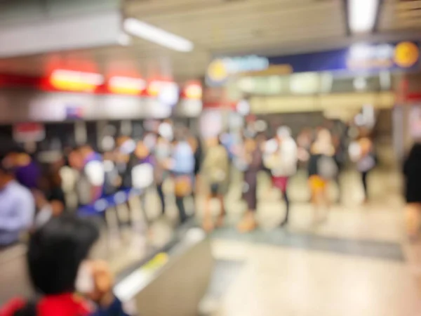 Blurred people in railway station waiting for train. Travel concept