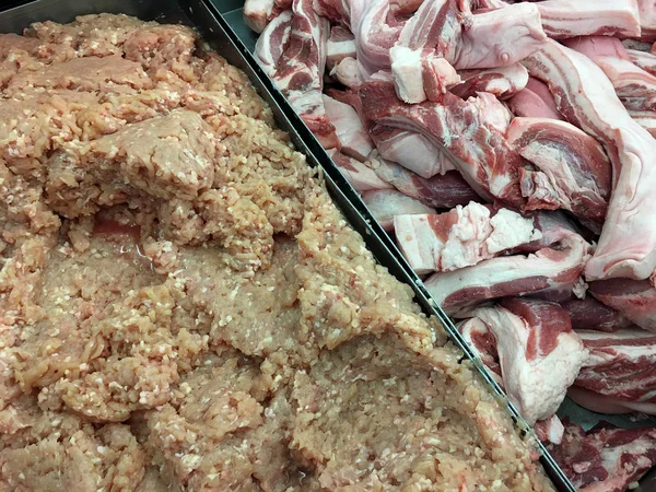 Fresh raw streaky pork belly and minced pork in plate two side at the supermarket or department. store