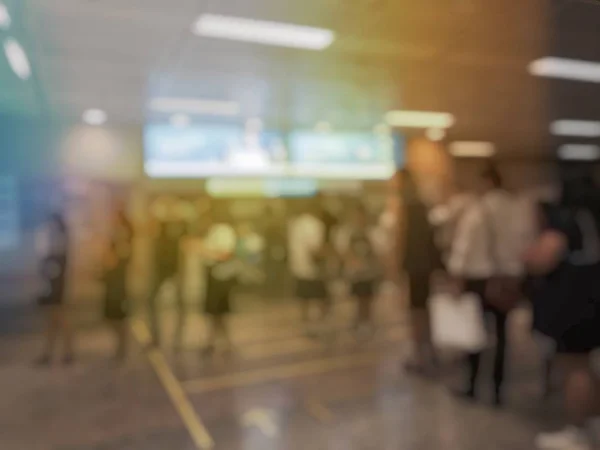 Blurred image of people in airport hall waiting for flight