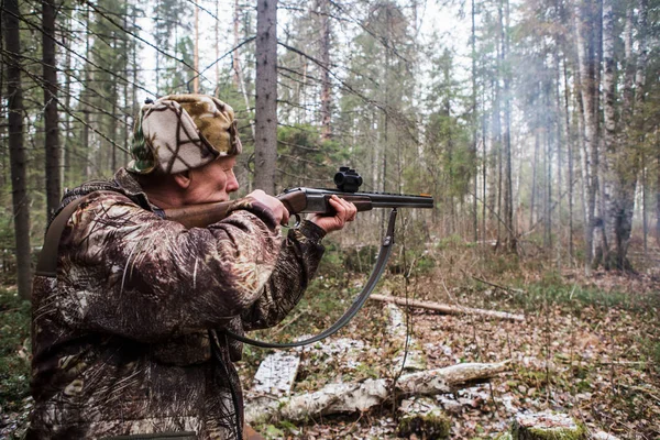 Male hunter shoots a gunw. Cloudy weather, autumn. — Stock Photo, Image