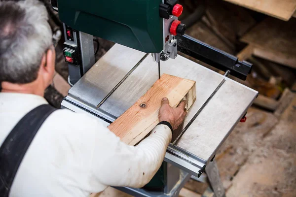 Man grinds wooden log — Stock Image Man grinds wooden log Stock Image