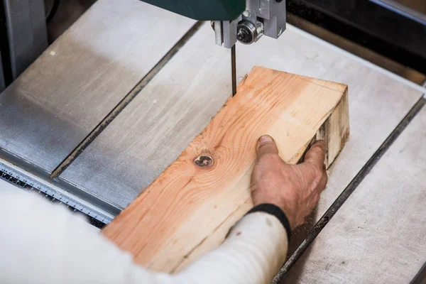 Man grinds wooden log — Stock Image Man grinds wooden log Royalty Free Stock Images