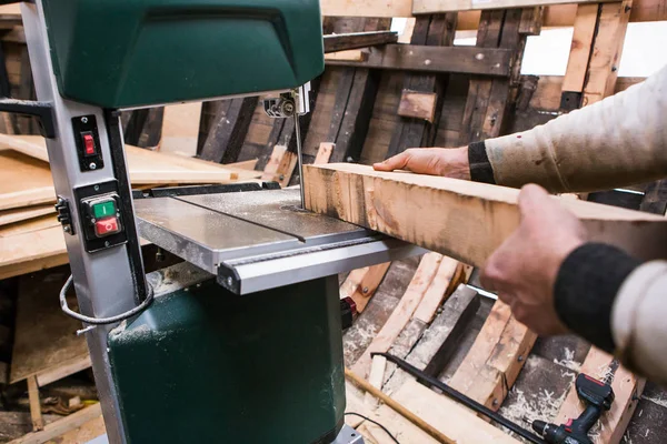 Man grinds wooden log — Stock Image Man grinds wooden log Royalty Free Stock Photos