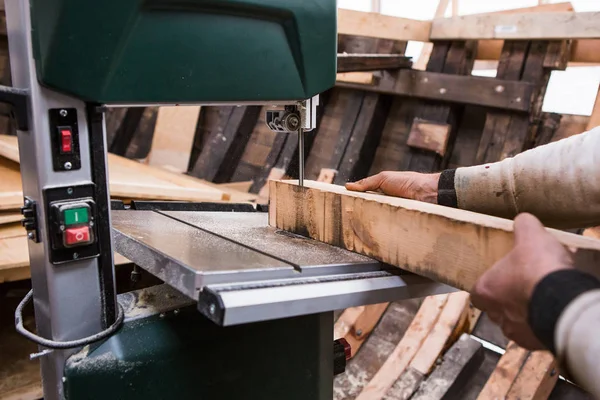 Man grinds wooden log — Stock Image Man grinds wooden log Stock Photo