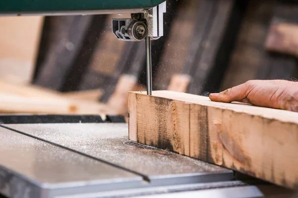 Man grinds wooden log — Stock Image Man grinds wooden log Stock Picture