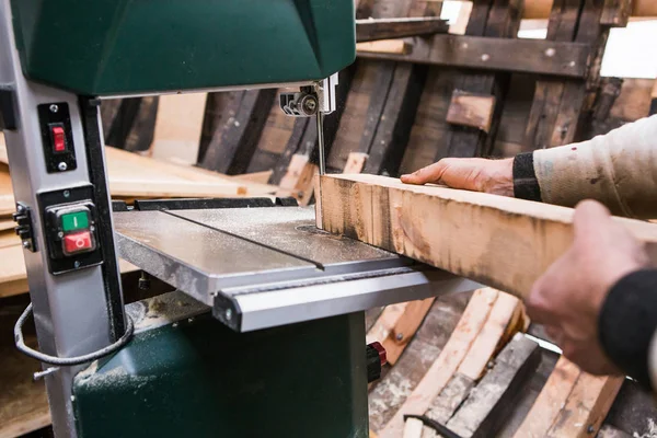 Man grinds wooden log — Stock Image Man grinds wooden log Stock Image