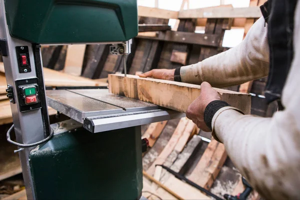 Man grinds wooden log — Stock Image Man grinds wooden log Stock Image