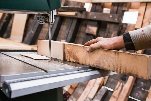 Man grinds wooden log — Stock Image Man grinds wooden log Royalty Free Stock Photos