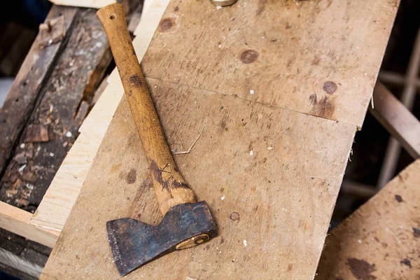 Axe on wooden plank — Stock Image Axe on wooden plank Stock Photo