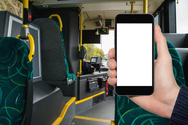 Hand with phone on the background of the city bus. — Stock Photo, Image