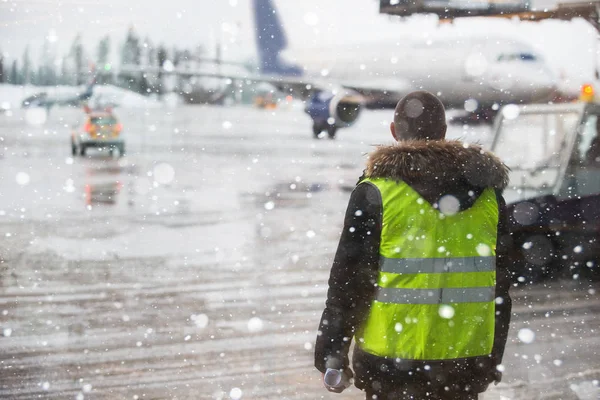 Gestionnaire d'aéroport debout sous les chutes de neige . — Photo