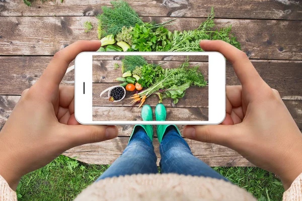 Woman taking picture of vegetables — Stock Photo, Image