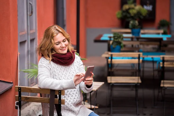 Woman is looking at phone. — Stock Photo, Image