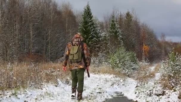 Hunter with hunting rifle walking in forest — Stock Video