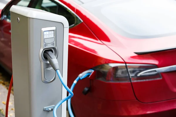 Close up of charging station with electric car — Stock Photo, Image