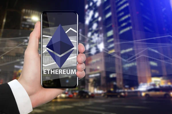 Man holding a phone with a ethereum symbol — Stock Photo, Image
