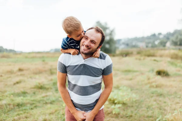 Father and son in nature in summer park