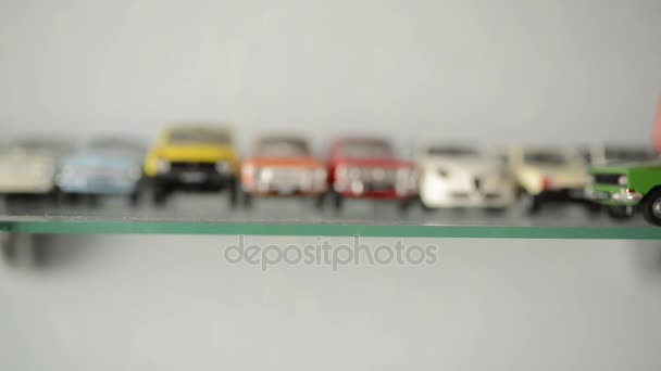 Collection of toy cars on the glass shelf. camera focus moves on cars — Stock Video