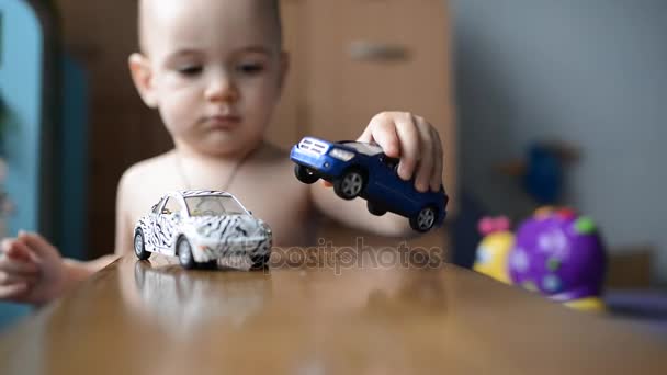 Niño jugando con coche de juguete — Vídeo de stock