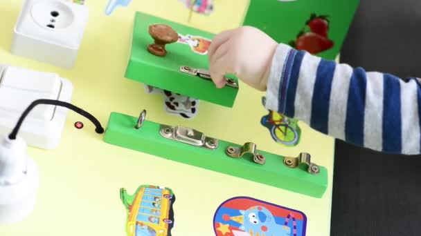 Pequeño bebé jugando intensamente con tablero ocupado — Vídeos de Stock