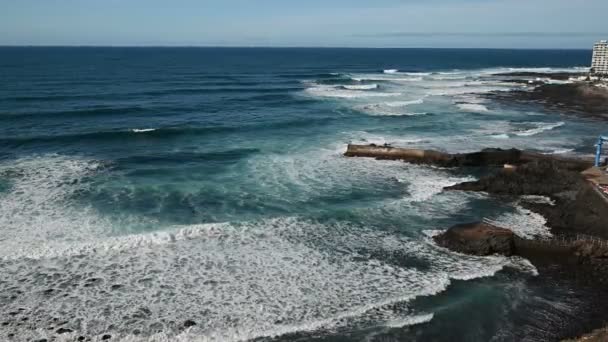 White foamy breaking waves on the beach with black volcanic sand on Tenerife. — Stock Video