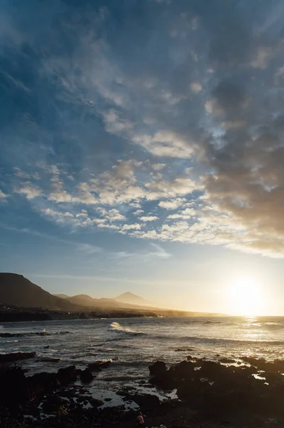 地平線の美しい夕日と山に面した海の波の上の飛行. — ストック写真