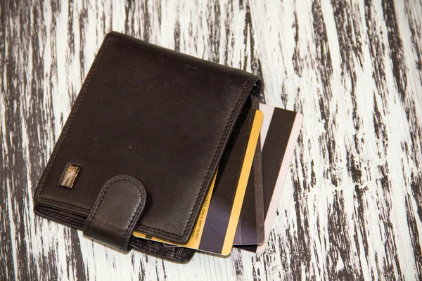 Leather wallet with credit discount cards. Artistic lighting and vintage processing. grunge background — Stock Photo, Image