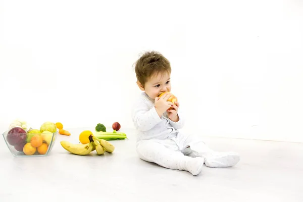 Bebé rodeado de frutas y verduras, nutrición infantil saludable — Foto de Stock