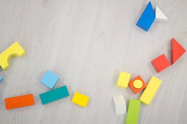 Scattered heap toy colored wooden bricks