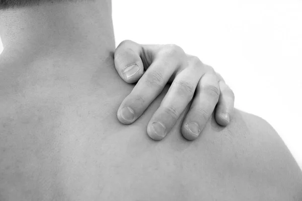 Schmerzen in der Schulter. Mann mit Rückenschmerzen. muskulöser männlicher Körper. isoliert auf weißem Hintergrund mit rotem Punkt. Gesundheitswesen und Problemkonzept unglücklicher Mann, der zu Hause unter Nacken- oder Schulterschmerzen leidet — Stockfoto