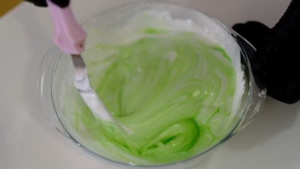 Young confectioner stirs mint mousse on table in kitchen pastry shop. Professional cooks delicious cream bowl in cuisine indoors. — 비디오