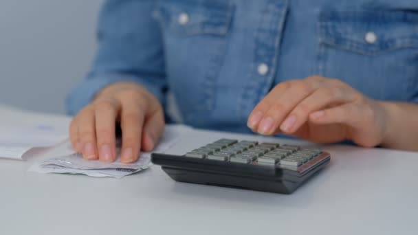 Count checks. young woman checking bills, taxes, bank account balance and calculating expenses in the living room at home — Stock Video