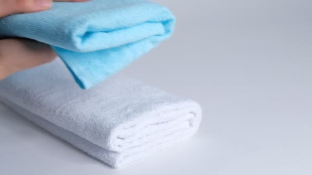 Zbliżenie rąk układających stos świeżych ręczników na prześcieradle. Room service sprzątanie pokoju hotelowego makro — Wideo stockowe