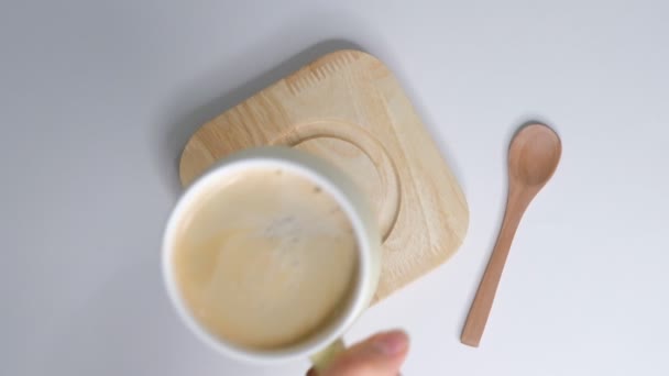 Female hands takes a cup of coffee. Woman warms her hands with hot coffee cup. Zoom out shot. Closeup Slow motion. — Stock Video