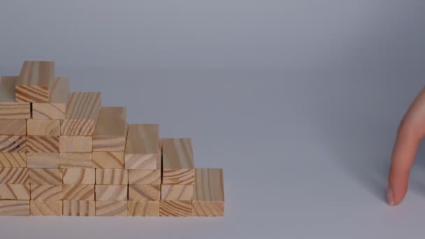 Stacked cubes and female hand imitating walking upstairs against white background. Concept of progress. Closeup Slow motion. — Stock Video