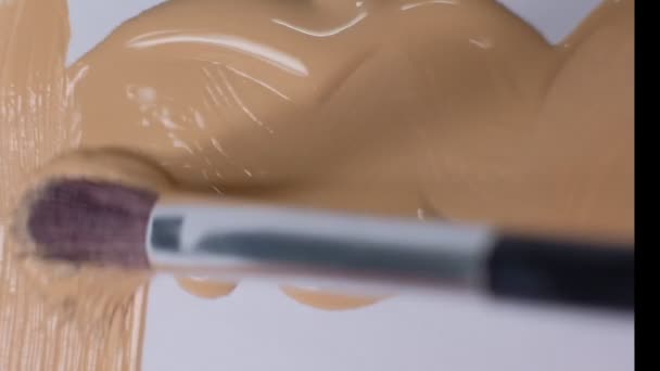 Smears of foundation for face. Cosmetic smear. Isolated on white background. Foundation face make-up smudge, smear. Cosmetic liquid foundation or bb cream beige. Closeup Slow motion. — 비디오