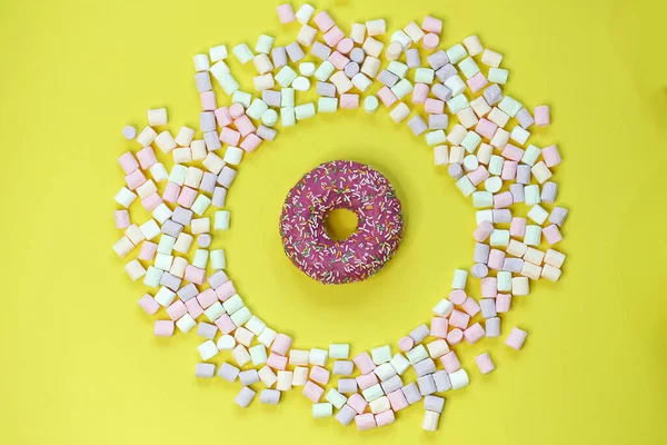 甜甜圈在一个黄色背景的圆形棉花糖框架上。顶视图照片 — 图库照片