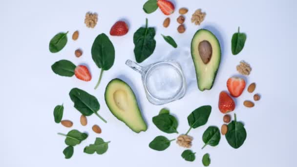 Smoothie aux épinards verts végétaliens sains. épinards et avocat sur fond blanc vue de dessus. Gros plan sur la cuisson au ralenti — Video