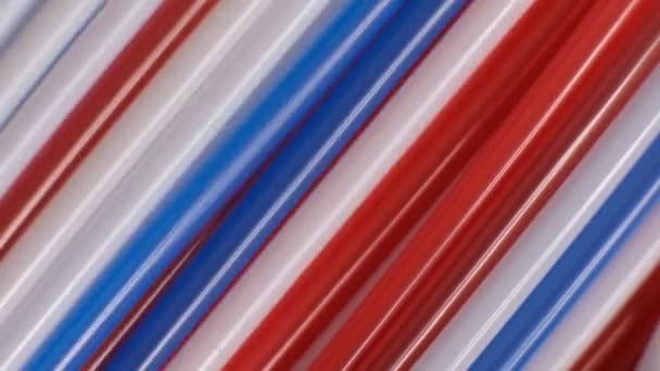 Colored cocktail plastic drinking straws rotates on white color background. Shot Slow Motion video — Stock Video