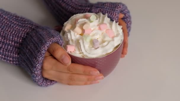 Woman holding mug of cocoa drink with whipped cream in hands Close up Shot video. — Wideo stockowe