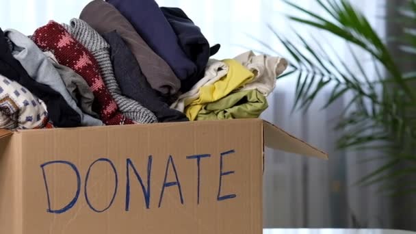 Donation concept. Man giving a donation cardboard box on a woman. Shot video. — Stock Video