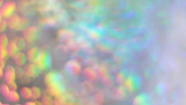 Gradient de néon de couleur. Le reflet de l'arc-en-ciel. Fond holographique. Fond flou abstrait mouvant. papier argenté à effet holographique. gros plan Shot Slow Motion vidéo 