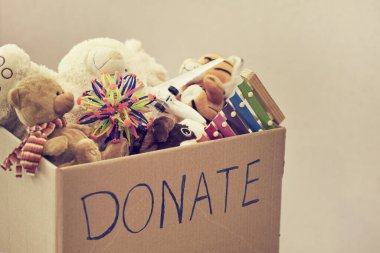 Donation box with children toys. woman collects toys for charity.